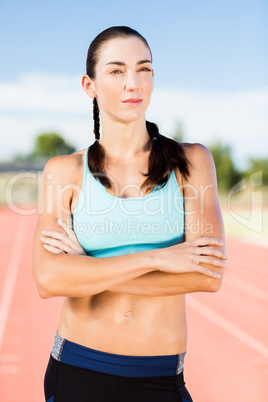 Confident woman standing with arms crossed