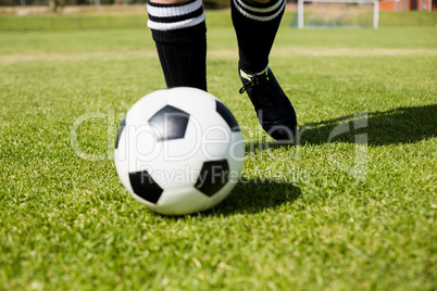 Female football player practicing soccer