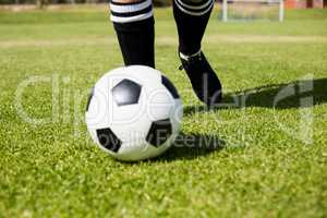 Female football player practicing soccer