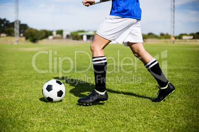 Female football player practicing soccer