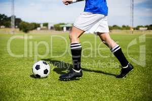 Female football player practicing soccer