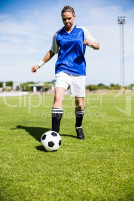 Female football player practicing soccer