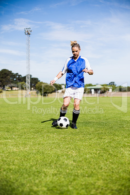 Female football player practicing soccer