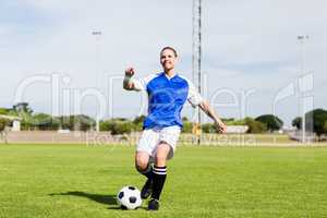 Female football player practicing soccer