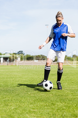 Female football player practicing soccer Female football player practicing soccer