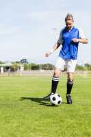 Female football player practicing soccer