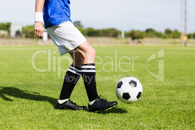 Female football player practicing soccer