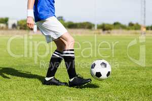 Female football player practicing soccer