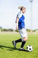 Female football player practicing soccer