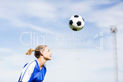 Female football player playing football