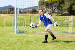 Female goalkeeper about to throw a football