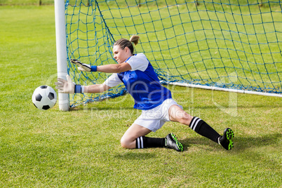 Female goalkeeper saving a goal