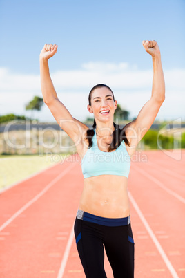 Happy female athlete posing after a victory