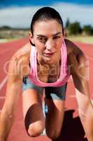 Portrait of female athlete in ready to run position