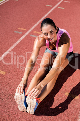 Portrait of female athlete stretching her hamstring