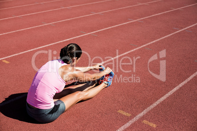 Female athlete stretching her hamstring