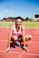 Portrait of happy female athlete warming up