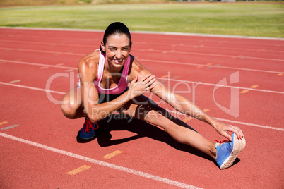 Portrait of female athlete stretching her hamstring
