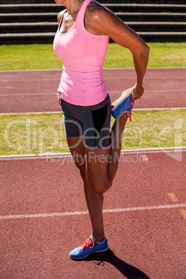 Female athlete warming up on the running track