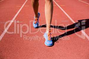 Female athlete feet running on the running track