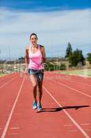 Female athlete running on the running track