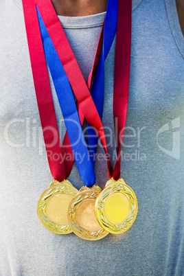 Athlete posing with gold medals around his neck