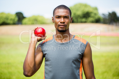 Male athlete holding shot put ball