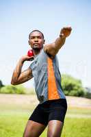 Male athlete about to throw shot put ball