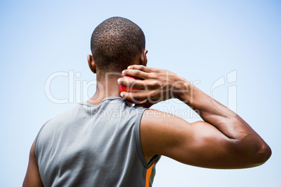 Male athlete about to throw shot put ball