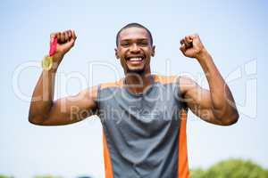 Athlete cheering with gold medal