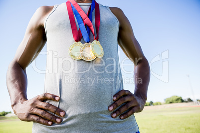 Athlete posing with gold medals around his neck