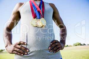 Athlete posing with gold medals around his neck