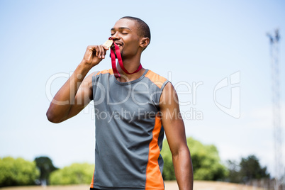 Athlete kissing his gold medal
