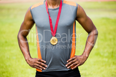 Athlete posing with gold medals around his neck