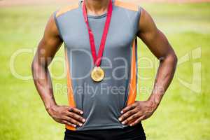 Athlete posing with gold medals around his neck