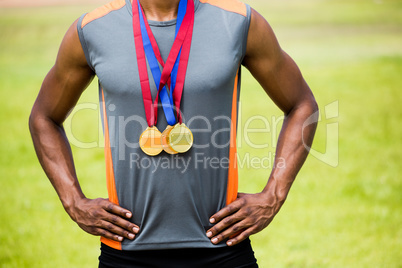 Athlete posing with gold medals around his neck