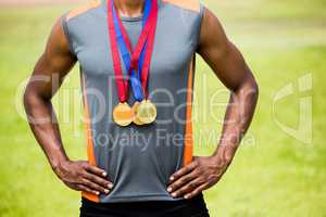 Athlete posing with gold medals around his neck