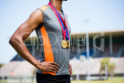 Athlete posing with gold medals around his neck