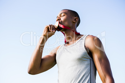 Athlete kissing his gold medal