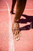 Hands of athlete on a starting line