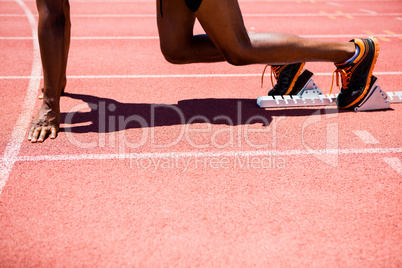 Athlete on a starting block about to run