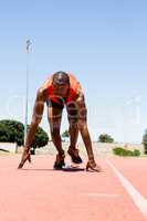 Athlete on a starting block about to run