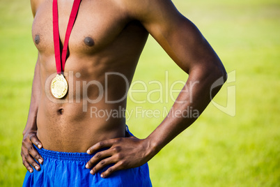 Athlete posing with gold medals around his neck