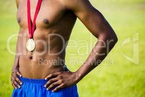 Athlete posing with gold medals around his neck