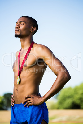 Athlete posing with gold medals around his neck