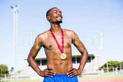 Athlete posing with gold medals around his neck