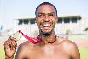 Athlete holding gold medal after victory