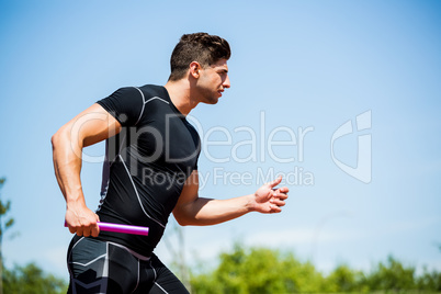 Relay athlete running with baton