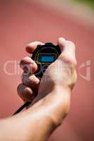 Hand holding a stopwatch