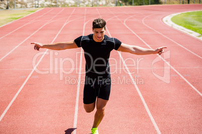 Athlete running on running track